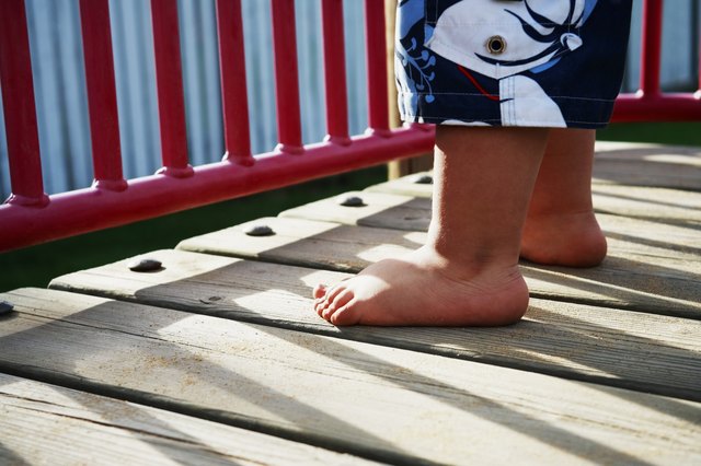 "Childs, feet, in, playground"