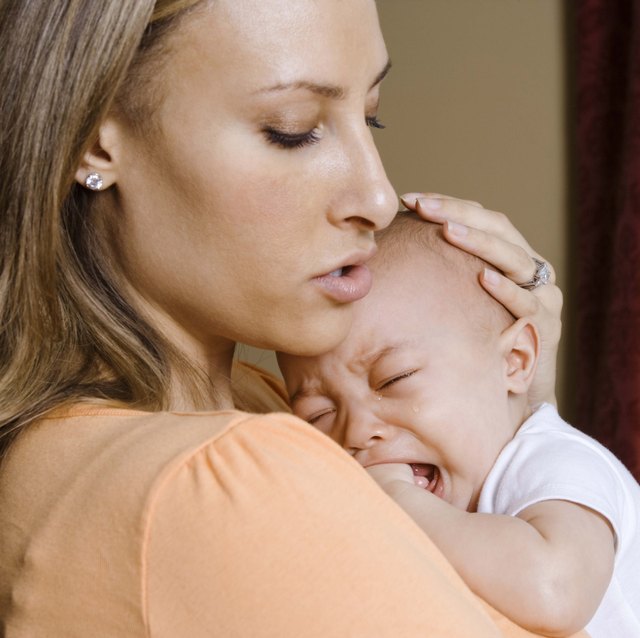 Mother holding crying son