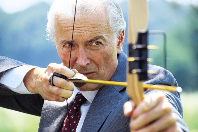 Executive archer shooting arrow