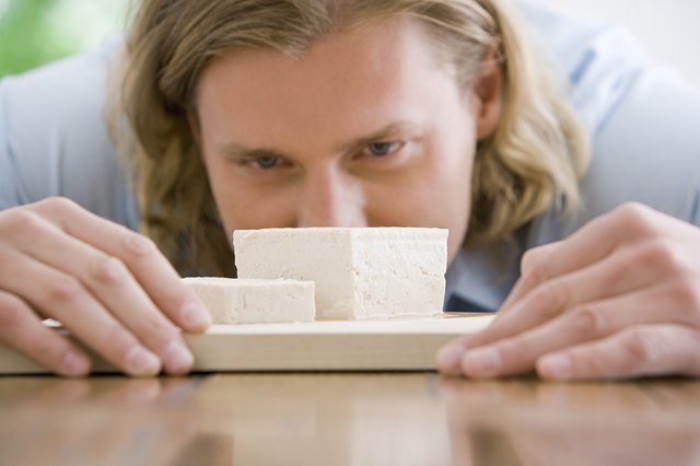 A man looking at tofu