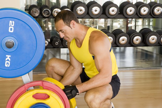 Man adjusting weights