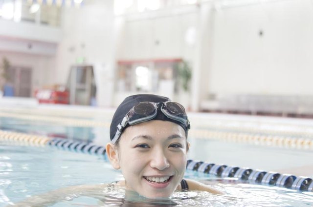 Young Woman Relaxing In Swimming Pool