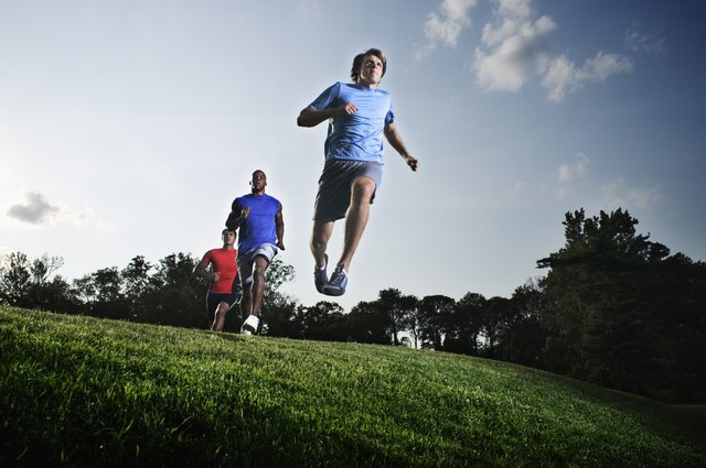Men jumping in field