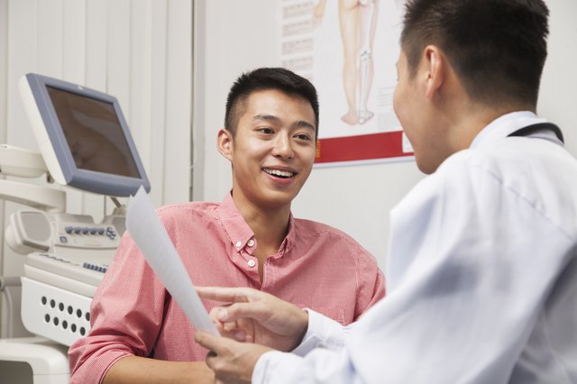 Young Man Talking With Doctor