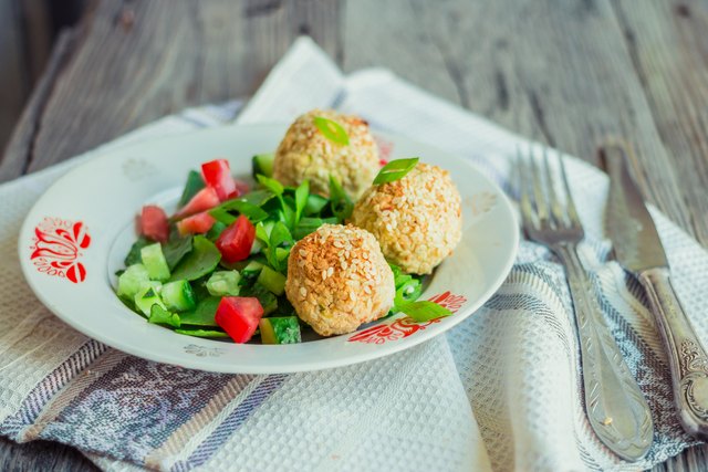 baked chickpeas balls with sesame and vegetable salad, rustic