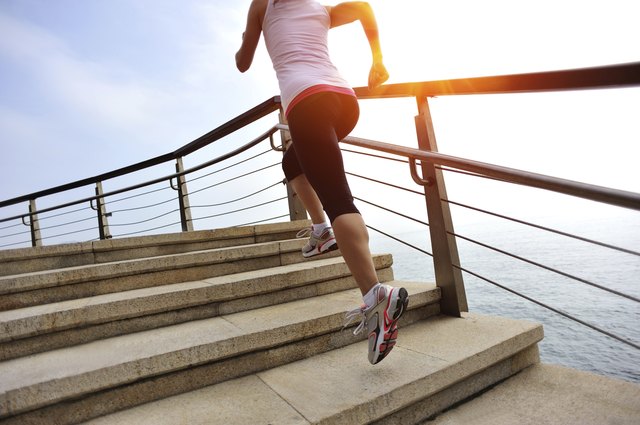healthy lifestyle asian woman running at stone stairs seaside