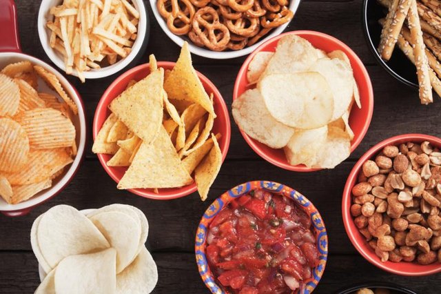 Tortilla chips and other salty snacks with homemade salsa