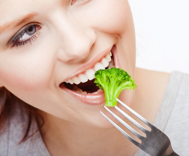 Girl eating Broussels sprout