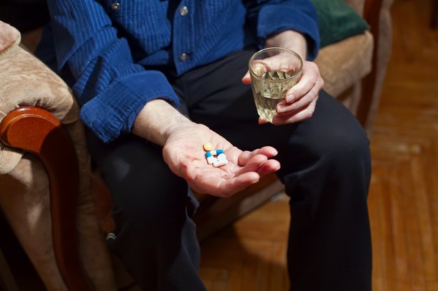 Old Man Taking Medicine