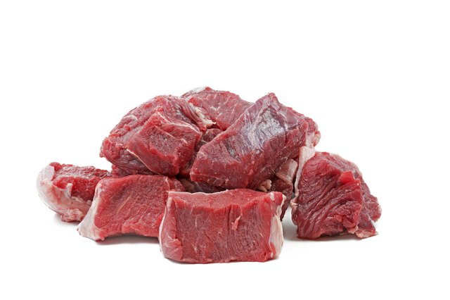 Pieces of raw beef goulash, isolated on white