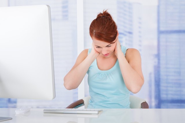 Businesswoman Suffering From Neckache At Computer Desk