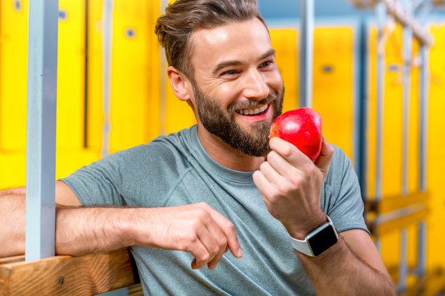 Man with apple in the gym