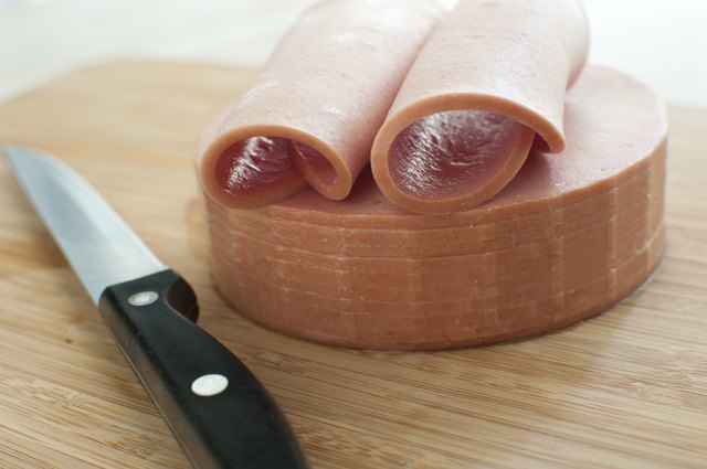 Sliced bologna sausage on cutting board