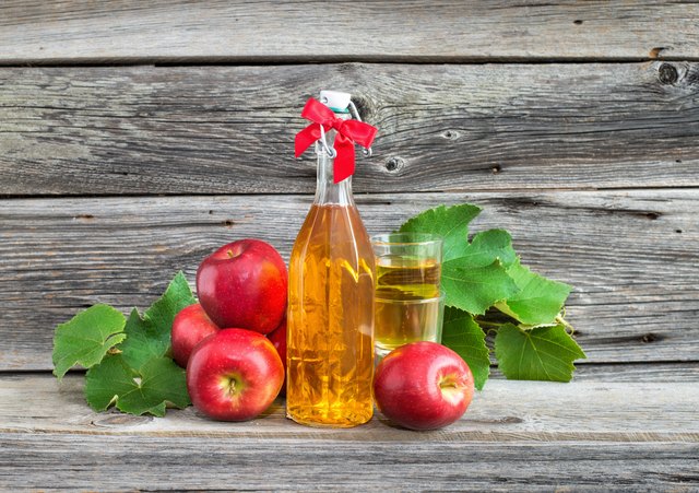 composition with apple juice in the bottle and apples
