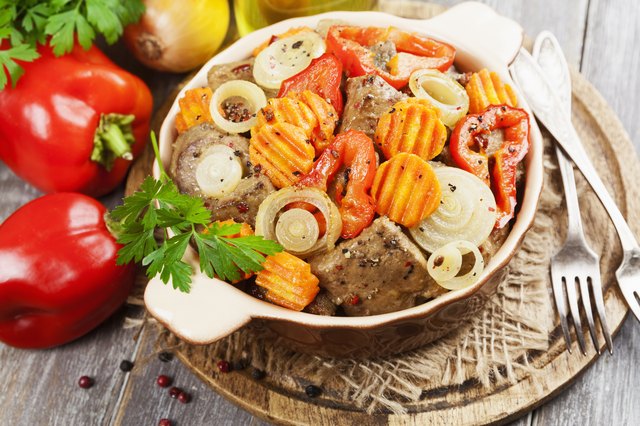 Liver fried with vegetables in the ceramic pot