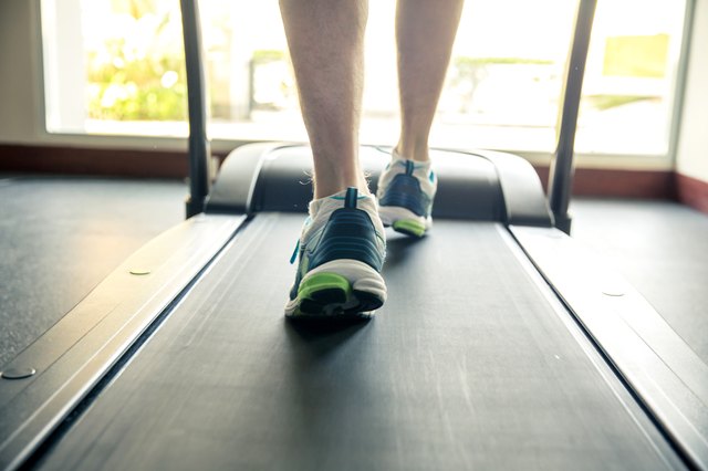 Young men walking on treadmill
