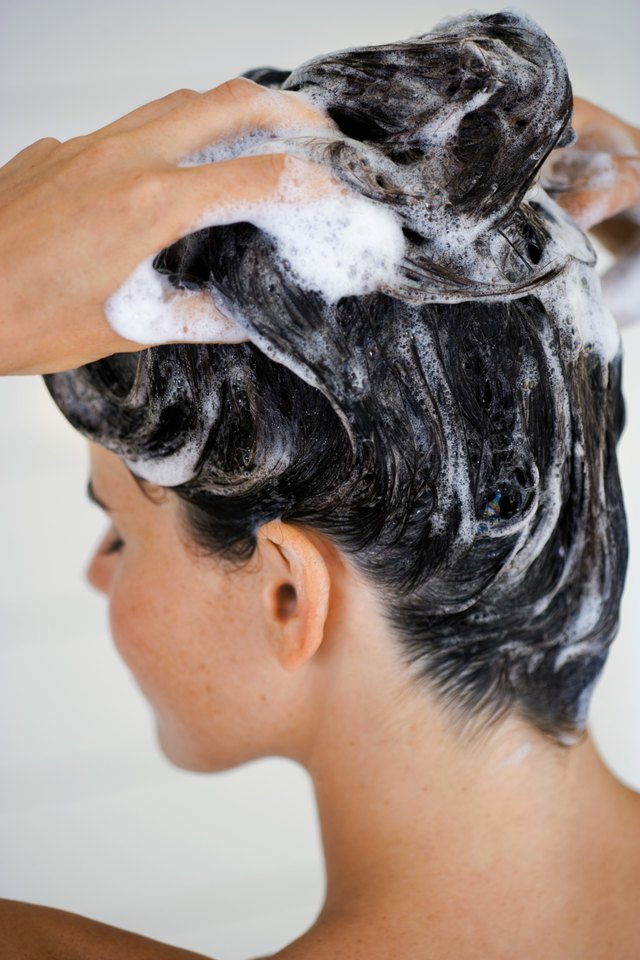 Woman shampooing hair