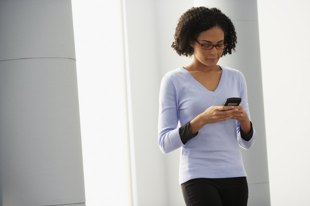 African businesswoman looking at cell phone