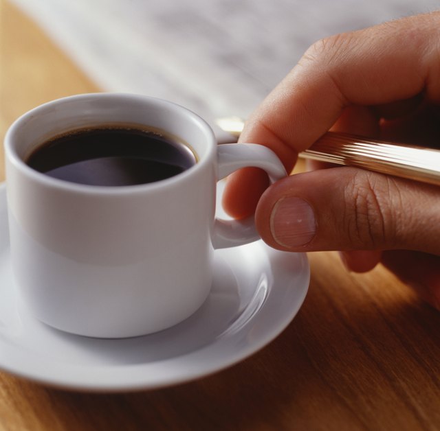Man taking cup of espresso, Close-up of hand