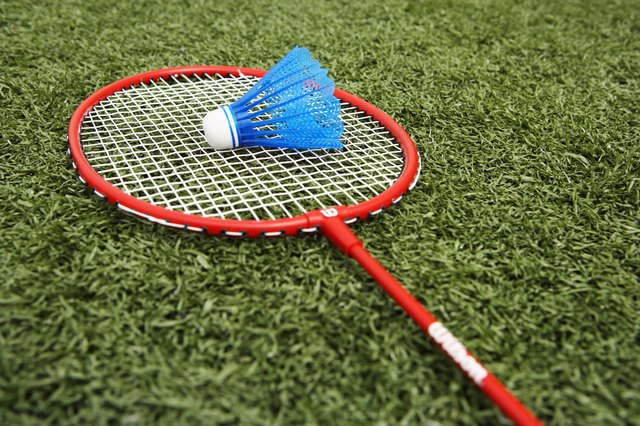 Badminton racket and shuttlecock on artificial turf