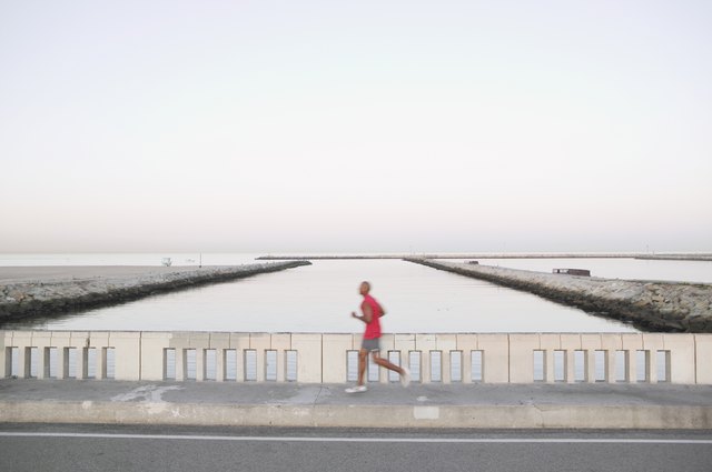 African American male runner on bridge