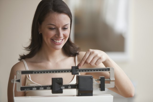 Close up of a woman weighing herself