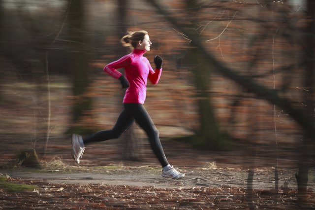 Young woman running outdoors in a city park