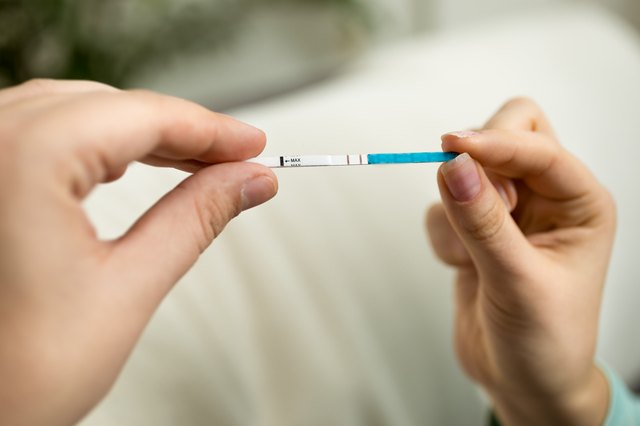 Closeup shot of woman holding positive pregnancy test