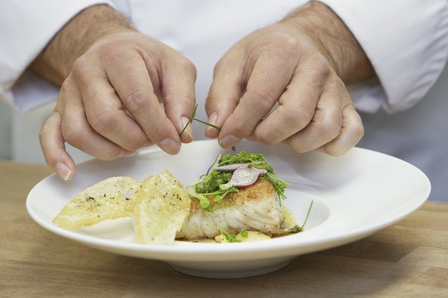 Male chef garnishing food close-up
