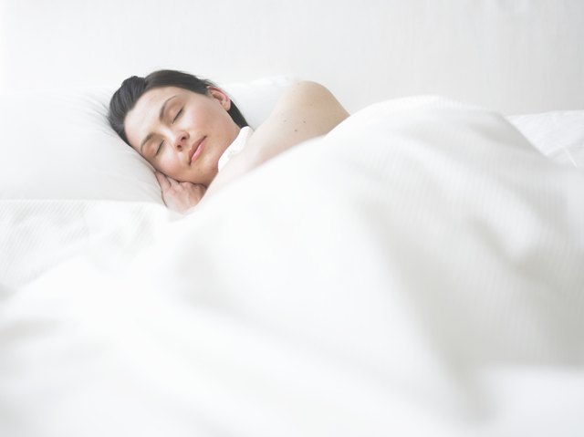Young woman asleep in bed