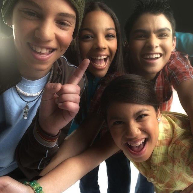 Four teenagers (13-15) smiling, portrait (Digital Enhancement)