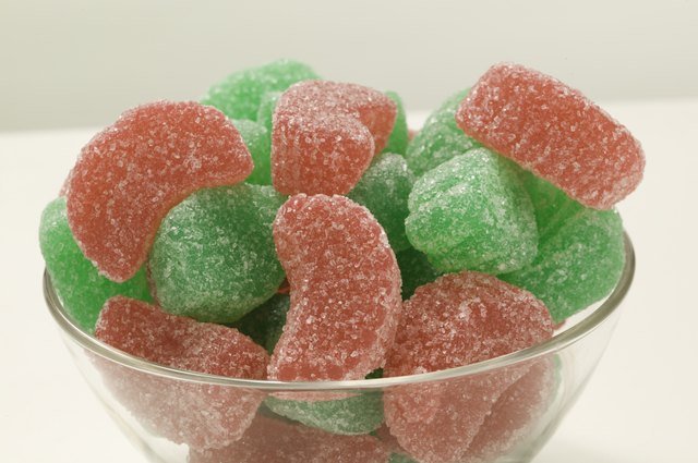 Green and red sugared candies in glass bowl