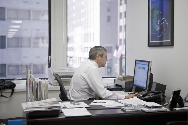 man in office using computer