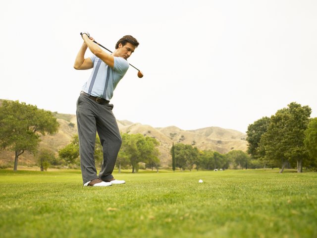 Golfer preparing to drive ball