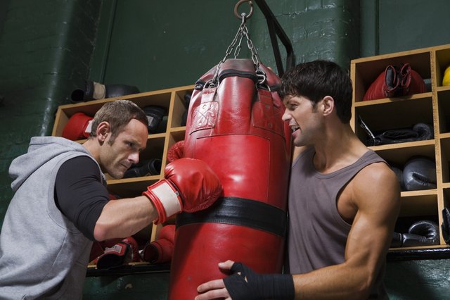 Boxers practicing with punching bag