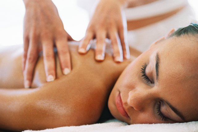 close-up of a young woman receiving a back massage