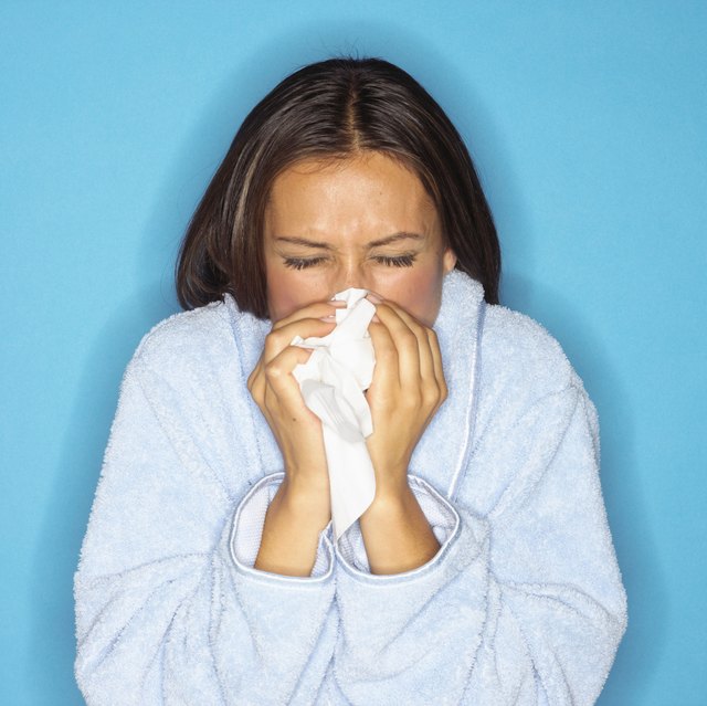 Sick Young Woman Blowing Her Nose