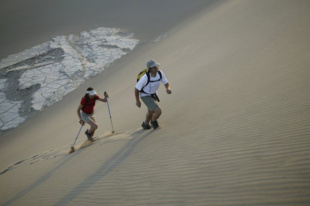 Man and woman hiking through desert