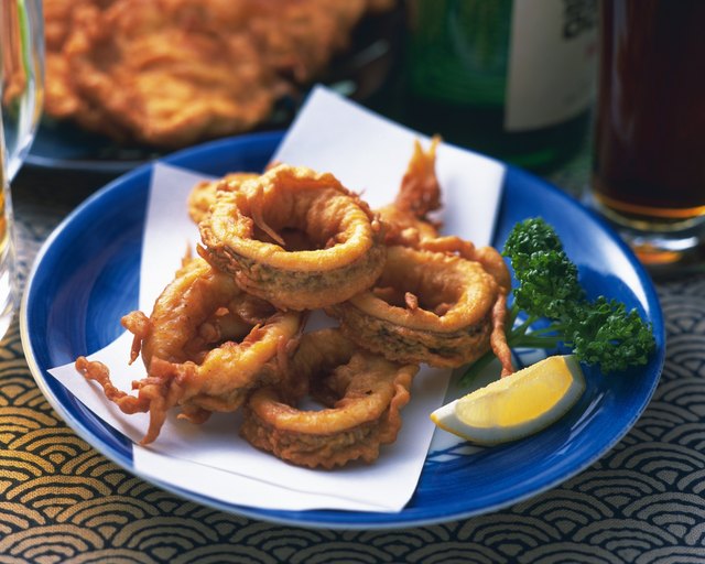 Sliced fried squid on plate, high angle view, differential focus