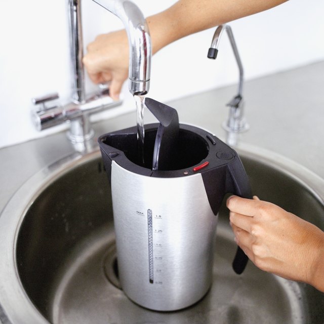 Close-up of an electric kettle being filled with water