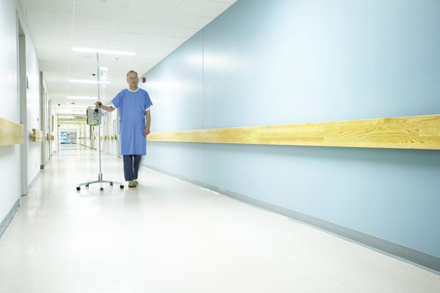 Male patient walking with an IV drip stand