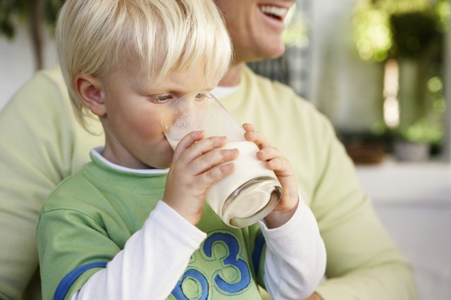 Boy in Fathers Lap Drinking Milk