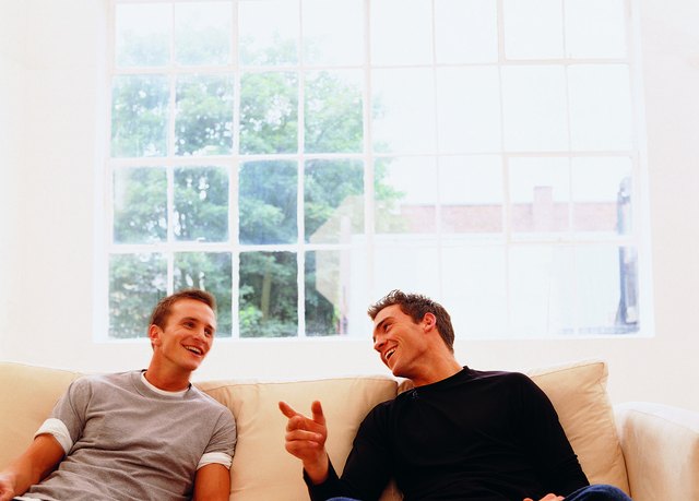 Two guys sitting together, talking