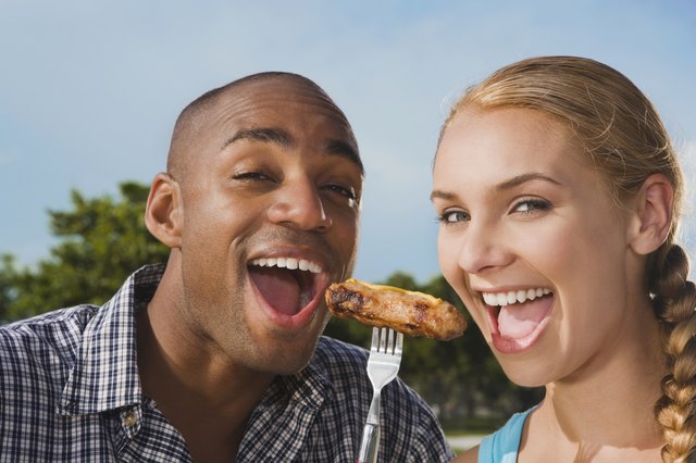 Multi-ethnic couple eating from same fork