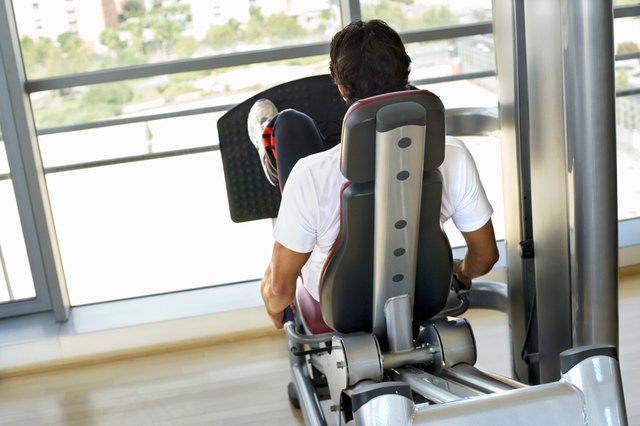 Rear view of a man using a leg press machine