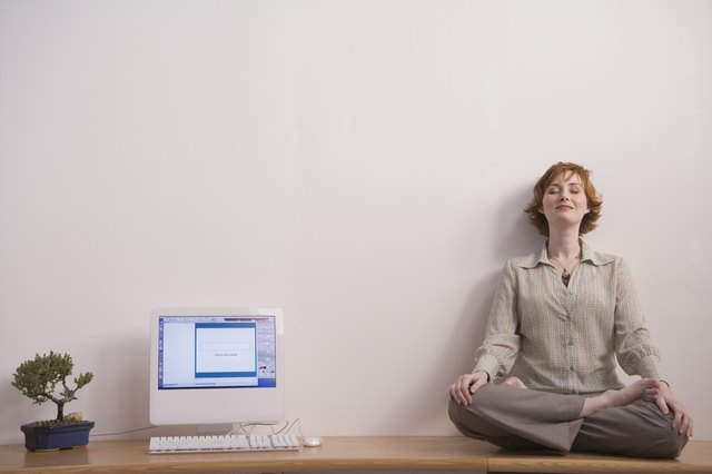 Woman meditating on desk