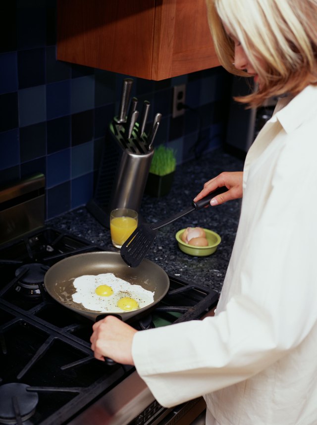 Woman frying eggs