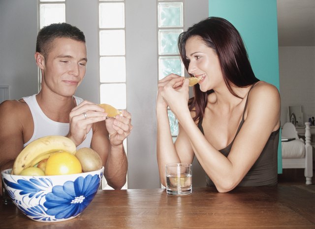 Couple eating fruit together