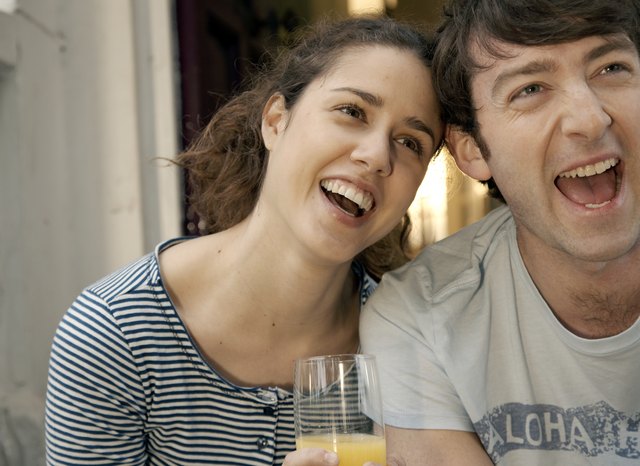 Couple laughing away from camera
