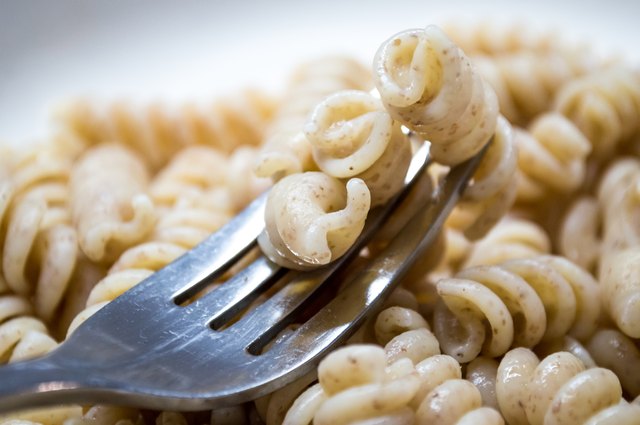 Cooked Plain Brown Wholewheat Fusilli Pasta on a Fork